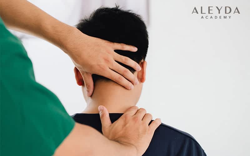Young Man Receiving Back Massage From Physiotherapist