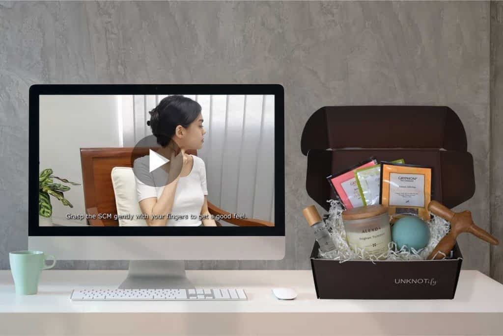 Computer-monitor-showing-neck-massage-video-next-to-wellness-box